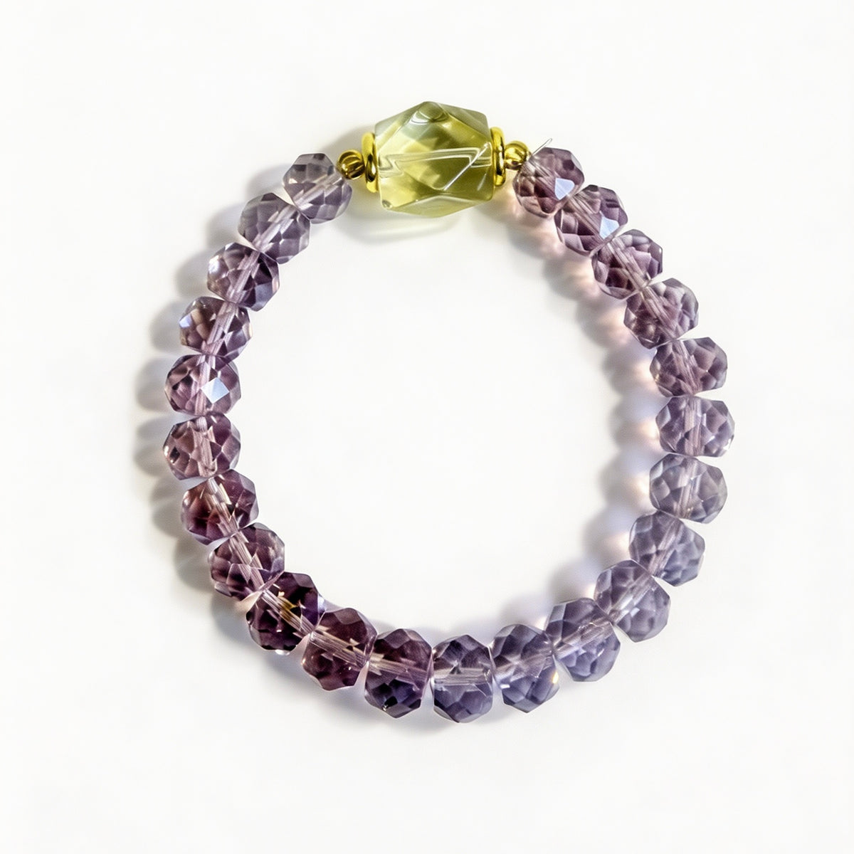 Purple faceted amethyst beads surrounding a lemon quartz focal stone on a stretch bracelet