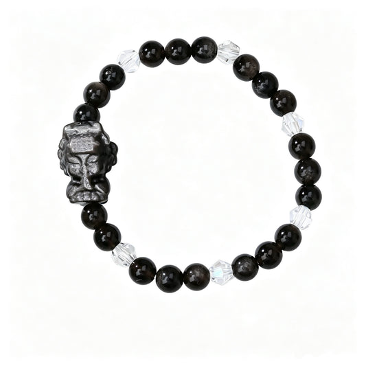 Black obsidian bead bracelet with carved guardian-head charm