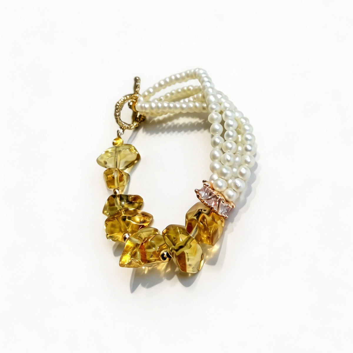 Close-up of creamy freshwater pearl strands and golden raw-cut citrine beads
