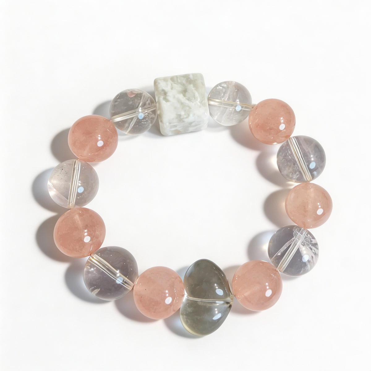 Rose quartz bracelet with clear quartz and rabbit hair crystal beads and a heart-shaped focal bead