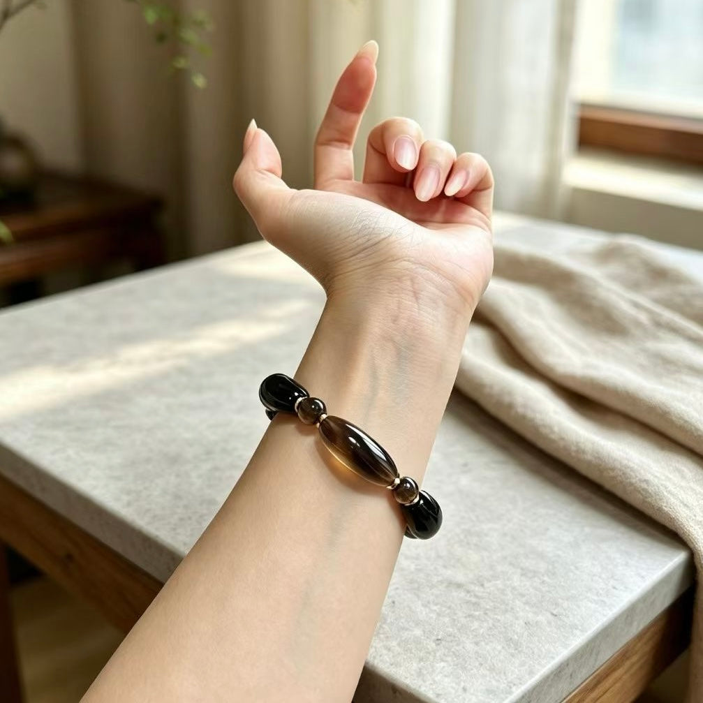 Smoky obsidian grounding bracelet worn on the wrist