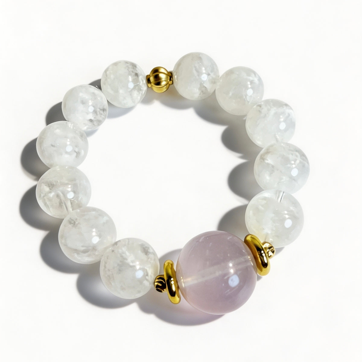 Snow phantom quartz bracelet with a pink rose quartz focal bead and gold-tone accents