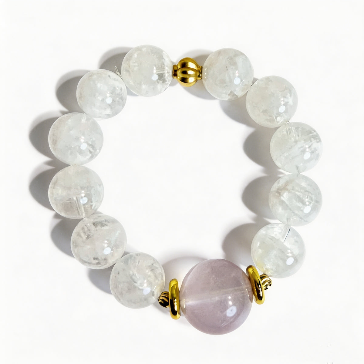 White snow phantom quartz beads and a pale pink rose quartz centerpiece on a crystal bead bracelet